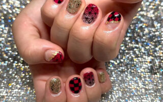 Short nails with red-and-black checks, geometric patterns and gold glitter accents by BARON